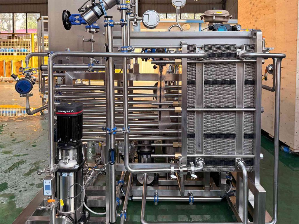 Plate heat exchanger and Grundfos pump on an in-line pasteurization skid